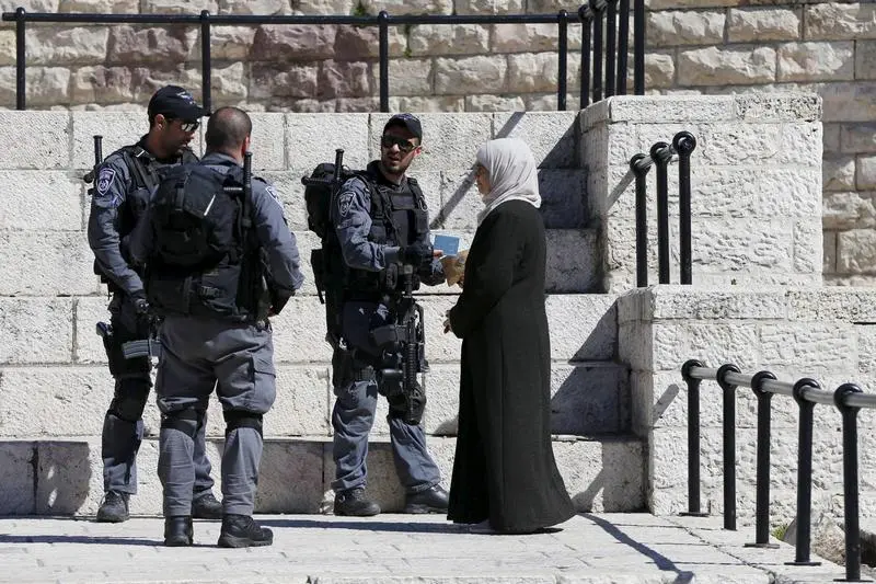 Israeli police check a Palestinian woman’s ID at Damascus Gate, highlighting life under occupation in Jerusalem’s Old City.
